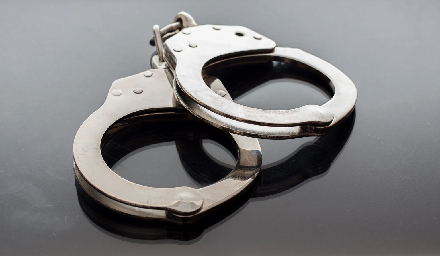 Steel handcuffs — Bruny's Bail Bonds answers 24 hours a day at 302.494.6212